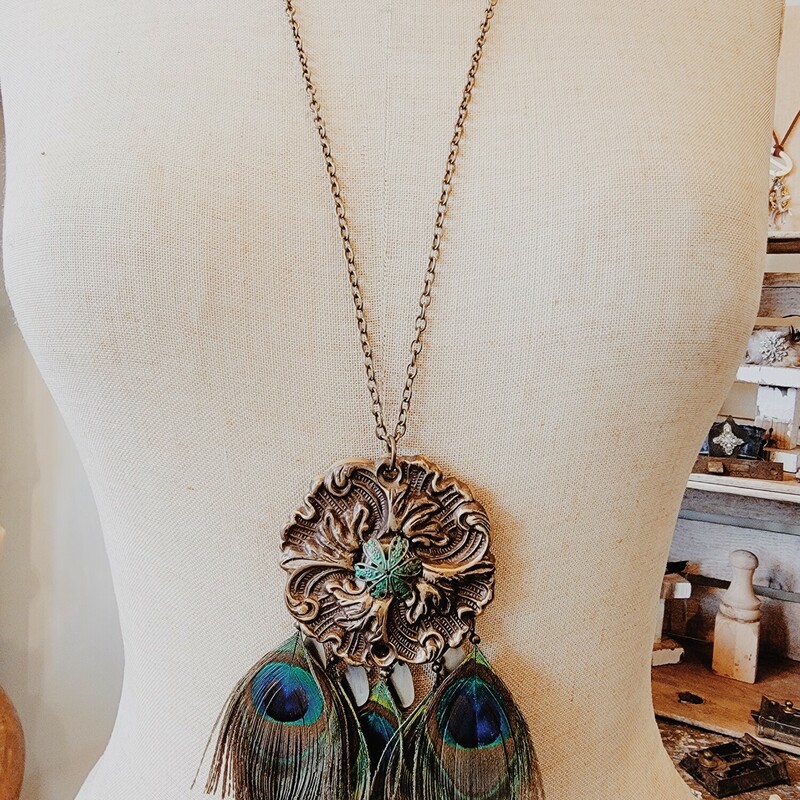 This beautiful necklace was hand crafted! The artist used a vintage floral medallion for the pendant and attached faux peacock feathers.
Chain: 32 Inches