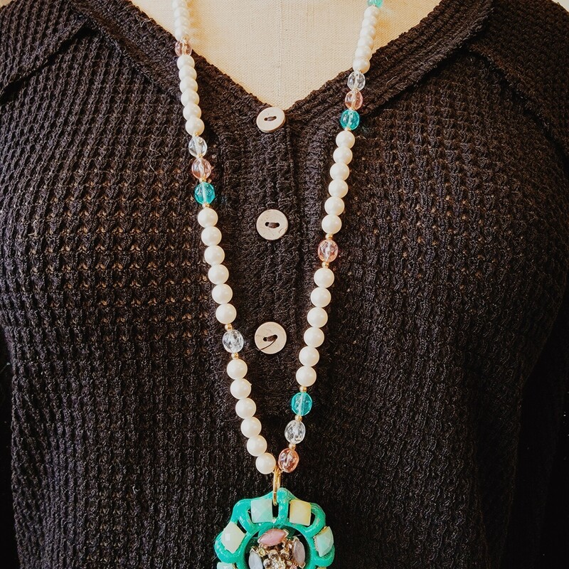 This one of a kind necklace was hand crafted! It is on a 34 inch beaded chain. Its pendant is a vintage waterhose knobs that has been repurposed with lovely stones!