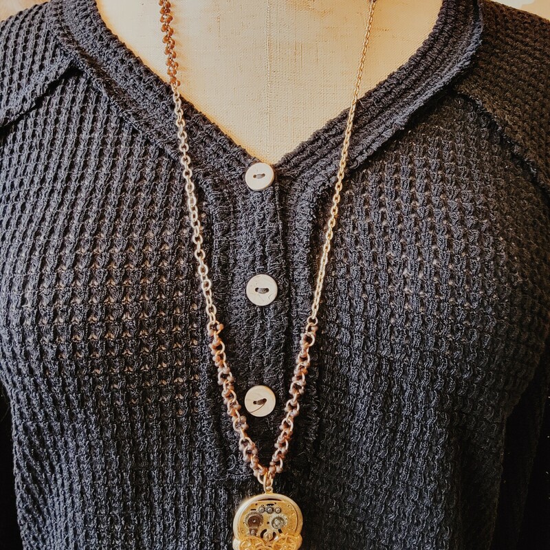 This adorable necklace is on a 32 inch chain with beads strung along portions. Its pendant is a collage of watch parts and faces!