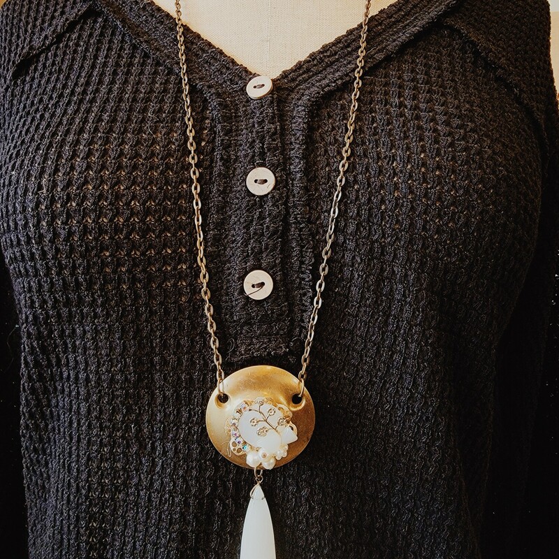 This elegant necklace was hand crafted!  It has a vintage door lock piece as its pendant with a collage of faux pearls on the center and a stone hanging from it.
Chain: 32 Inches