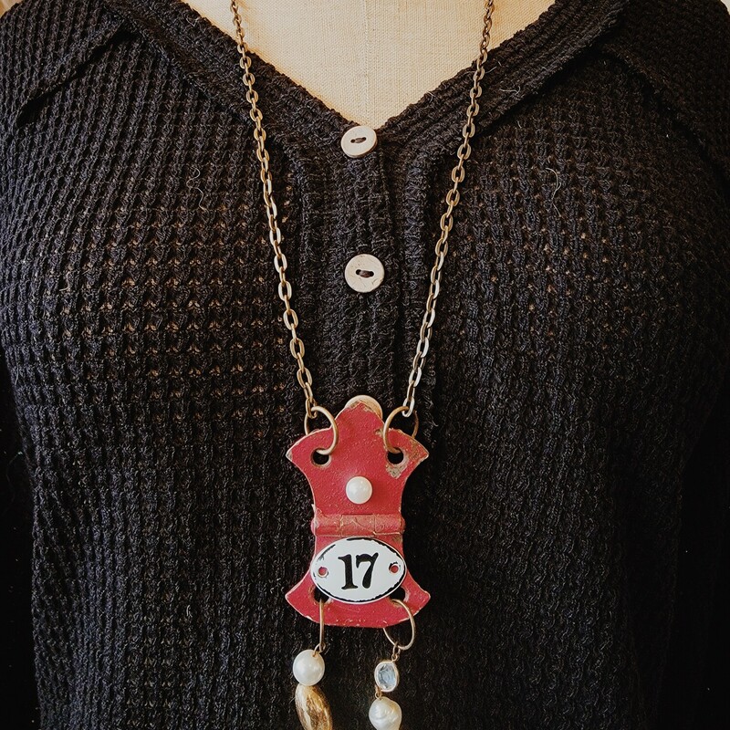 This adorable necklace was hand crafted! The artist used a vintage red hinge as the pendant and attached the number 17 with two strands of beads hanging below.
Chain: 30 Inches