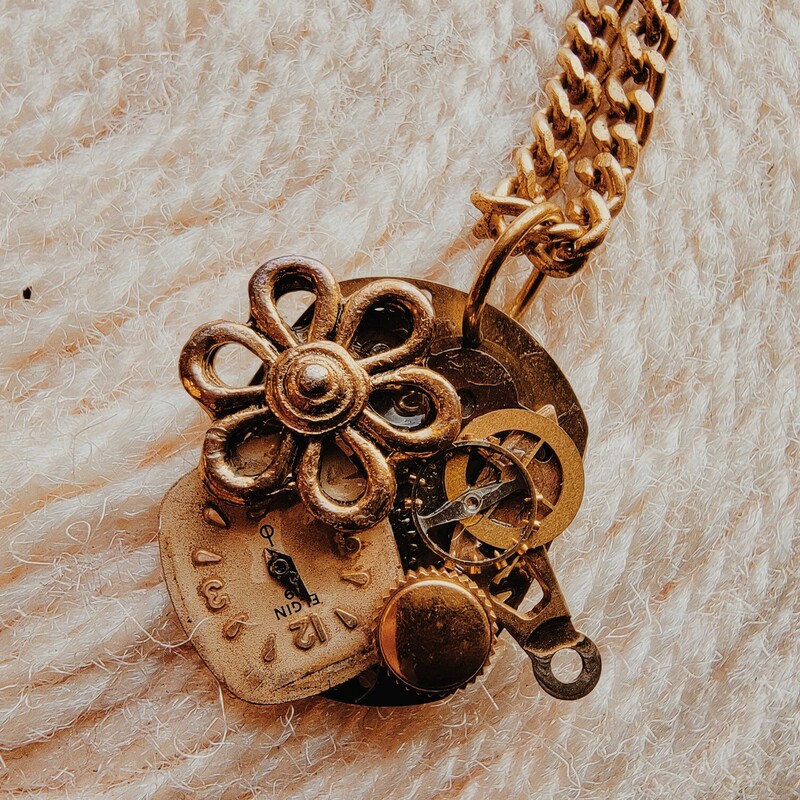This adorable necklace was hand crafted! The pendant is a collage of different watch faces and parts!<br />
Chain: 30 Inches
