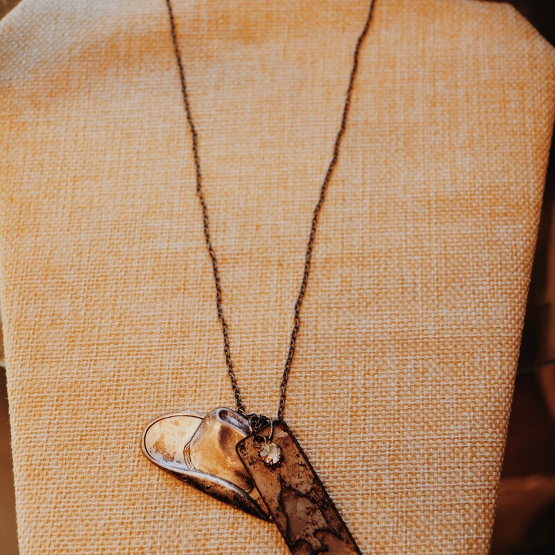 This necklace from Kelli Hawk Designs was handmade from vintage pieces! The centerpiece features two vintage metal pieces, one of which is a cowgirl hat. This hangs on a 19 inch chain.