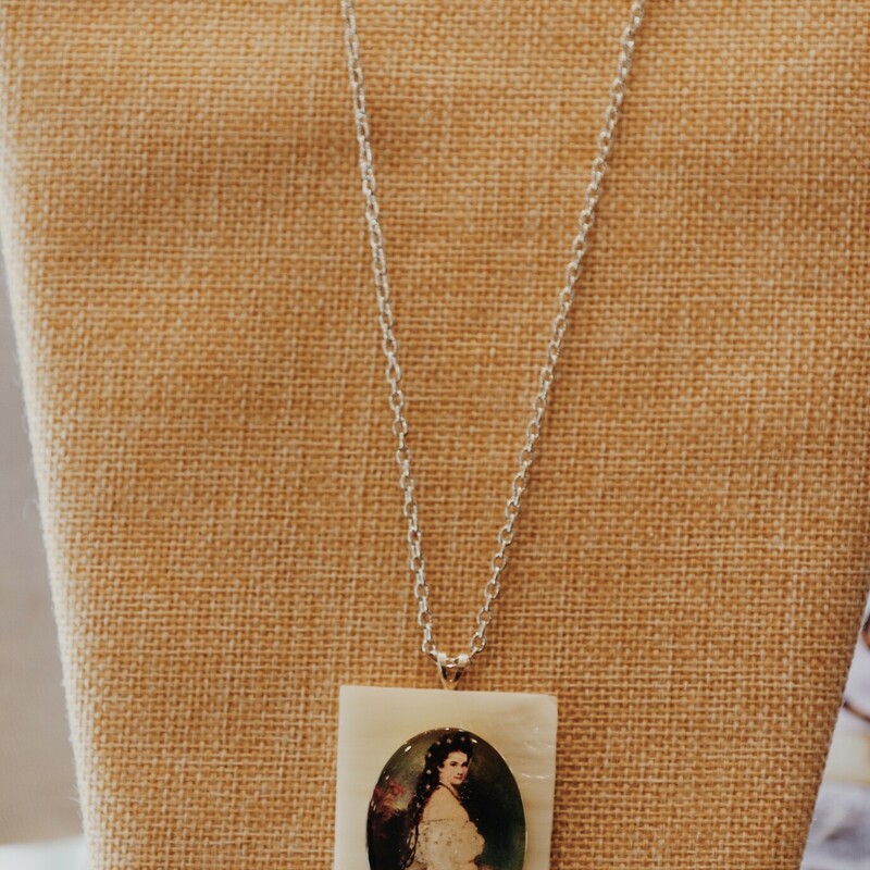 This handmade necklace by Kelli Hawk Designs has a beautiful portrait as its pendant and hangs on a 20 inch chain!