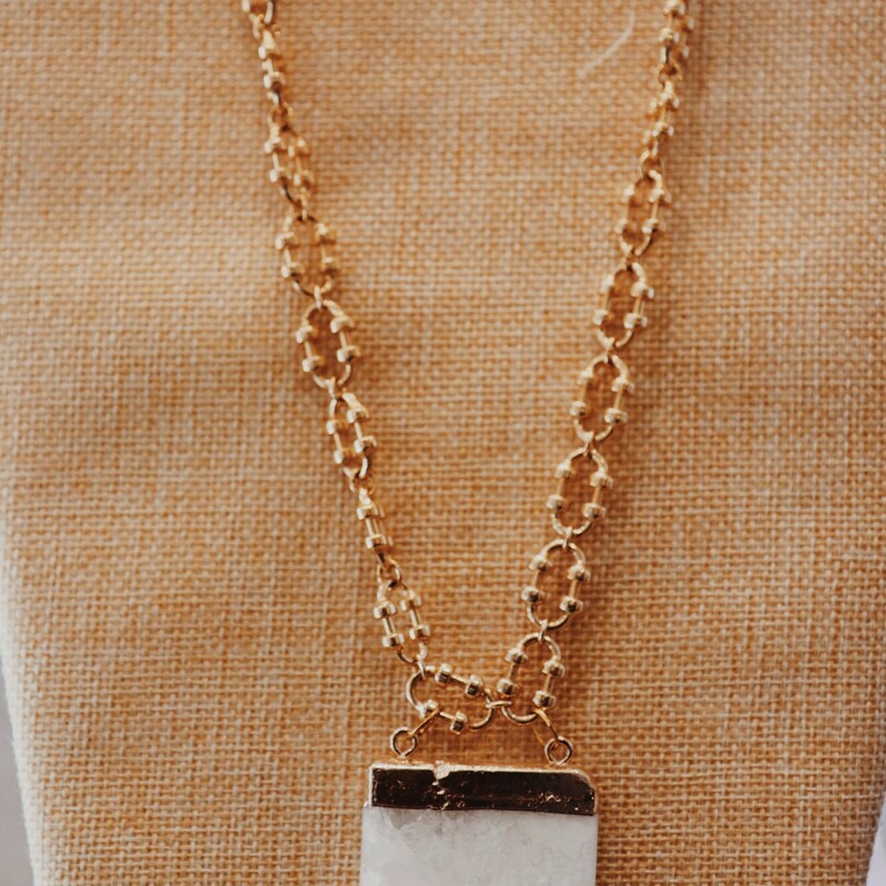 This necklace by Kelli Hawk Designs features a large white crystal as the centerpiece and hangs on a 18 inch gold chain!