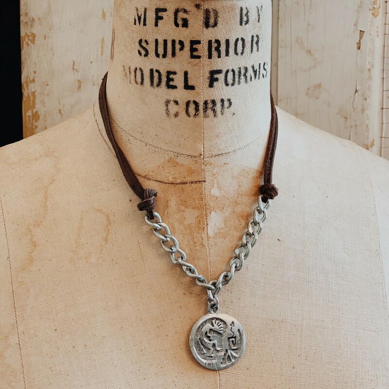 This awesome necklace features a silver tribal coin pendant. The 18 inch chain starts as leather and transitions into a chunky silver chain.