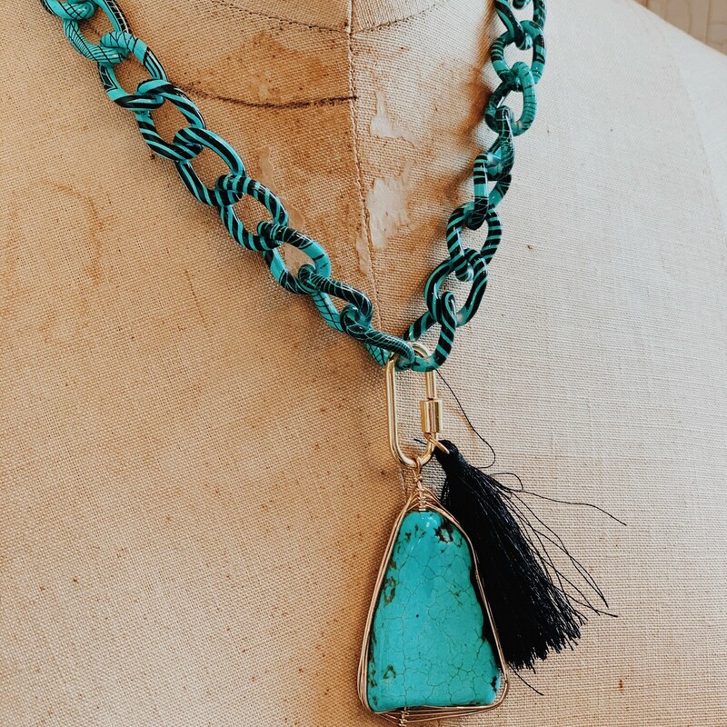 This Kelli Hawk Designs necklace is so fun and makes a statement! It is on a 17 inch turquoise and black chain with a 3 inch extender. A black tassel and a turquoise stone hang from this chain.