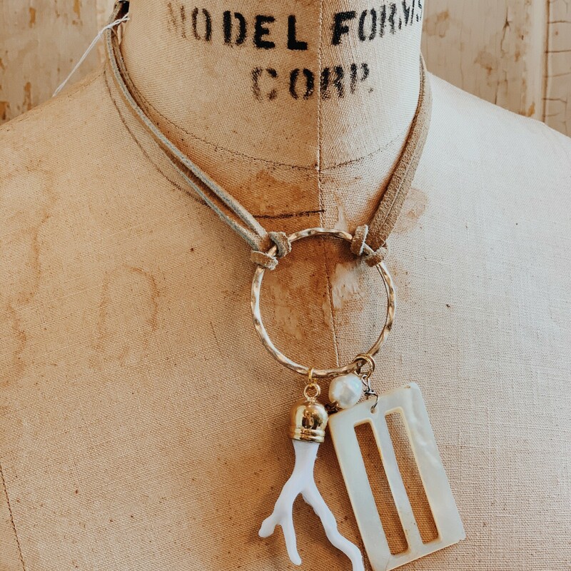 This handmade Kelli Hawk Designs necklace is on a 15 inch leather cord. From a lovely silver hoop hangs a mother pearl buckle, a pearl, and an antler!