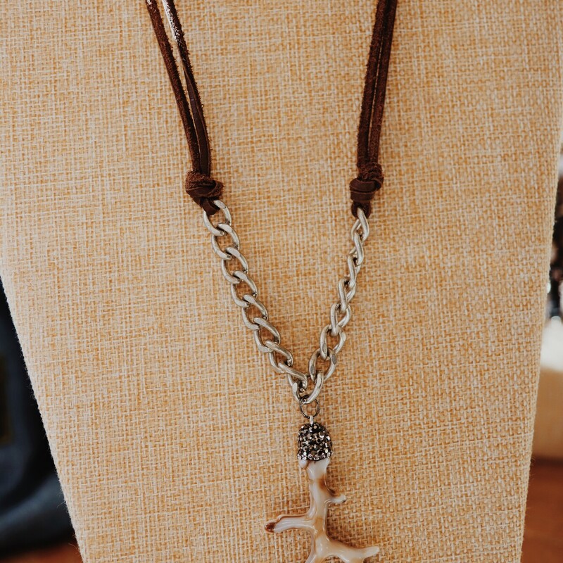 This handmade Kelli Hawk Designs necklace is on an 18 inch chain that transitions from leather cording to a silver chunky chain. The pendant is an adorable little antler!