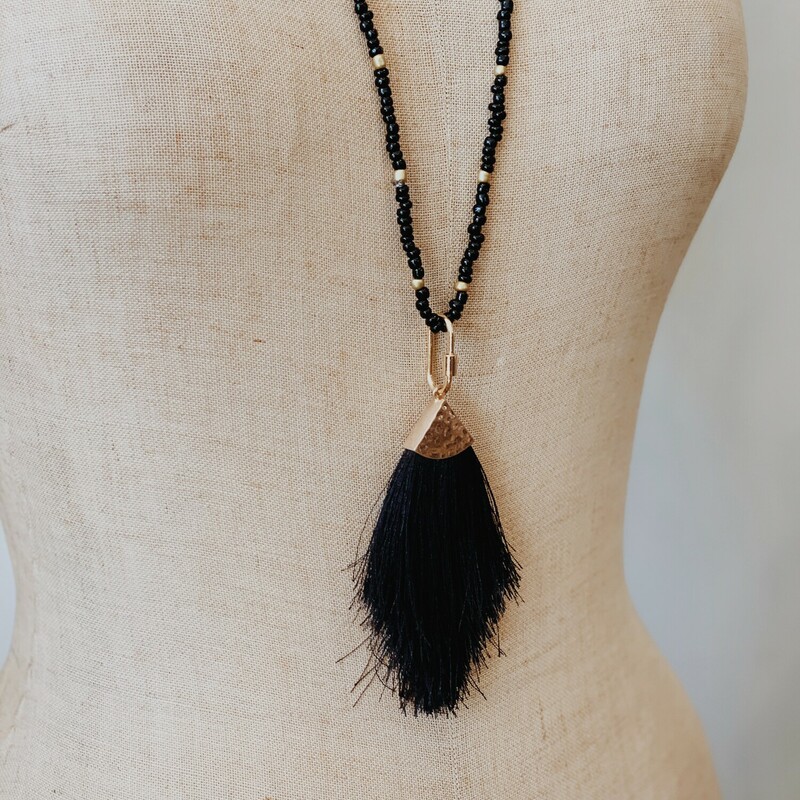 This black tassel necklace is on a 32 inch beaded cord. This beautiful necklace is black with gold accents!