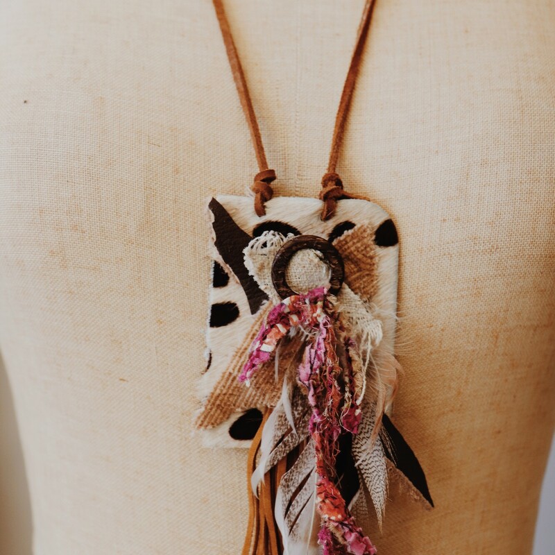 This one of a kind Kelli Hawk Designs necklace is on a 28 inch leather cord and has an assembly of fabrics, feathers, and leather as the pendant!