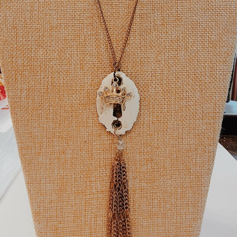 This adorable Kelli Hawk Designs necklace is on a 25 inch chain with a 2 inch extender and has a vintage keyhole as the pendant. The gold crown and gold chain tassel are so unique and perfect for a one of a kind look!