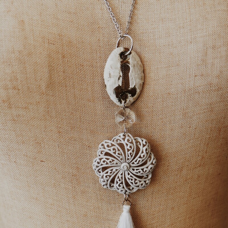 This lovely Kelli Hawk Designs necklace is on a 26 inch chain. The centerpiece consists of a vintage keyhole, a vintage broach, and a white tassel!