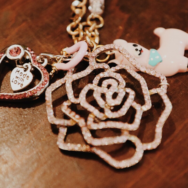 This handmade necklace by Kelli Hawk Designs is on a 20 inch mix matched chain with an XO on it! The centerpiece is a mix of charms that include a vintage flower, a pink llama, and a pink heart.