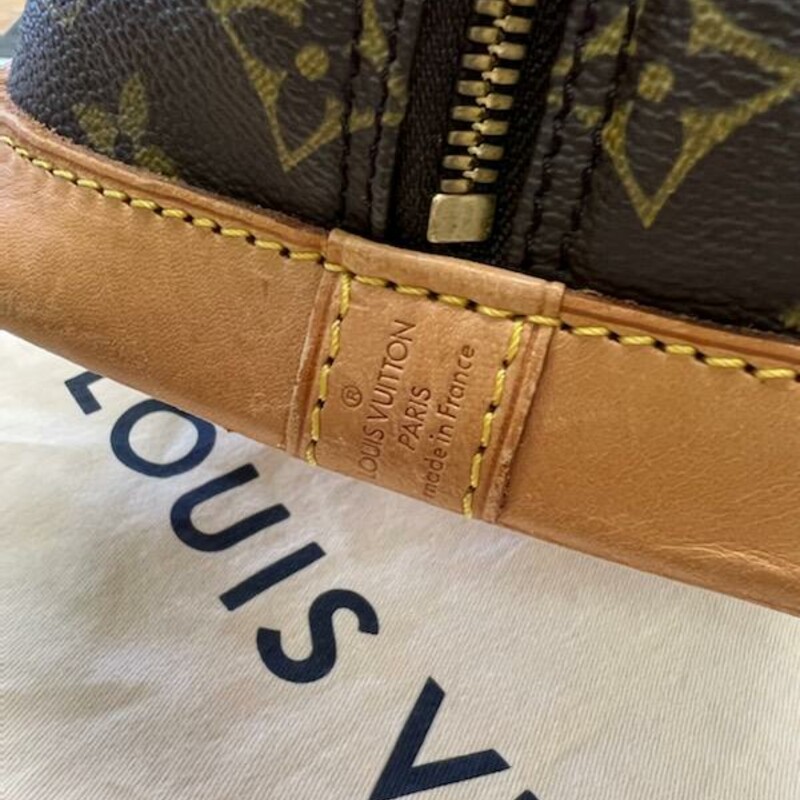 LOUIS VUITTON - Vintage<br />
MONOGRAM CANVAS ALMA PM<br />
The timeless Louis Vuitton Alma rendered in the house's signature coated Monogram Canvas with natural Vachetta leather trim and accented with gold-tone brass hardware.<br />
-Some things in life age like fine wine- luxury accessories included. I have a true love and appreciation for heritage luxury that has lived quite a life, perceiving darkened patina and marked Vachetta to be an indicator of a well-traveled item. The addition of true vintage amplifies any collection, rounding out the depth of style that sometimes shiny, new bags just cannot - even with scars and bruises - are still beautiful.<br />
Features:<br />
Two Leather Top Handles<br />
Zip-around Closures<br />
Interior Slash Pocket<br />
Coated Canvas<br />
Canvas Lining<br />
Gold Hardware<br />
Details:<br />
Length: 12\" (30 cm)<br />
Height: 9.4\" (23 cm)<br />
Depth: 6.25\" (15 cm)<br />
Strap Drop: 3.25\" (8 cm)<br />
Date Code:  BA1904<br />
This bag does come with its Original Duster Cover