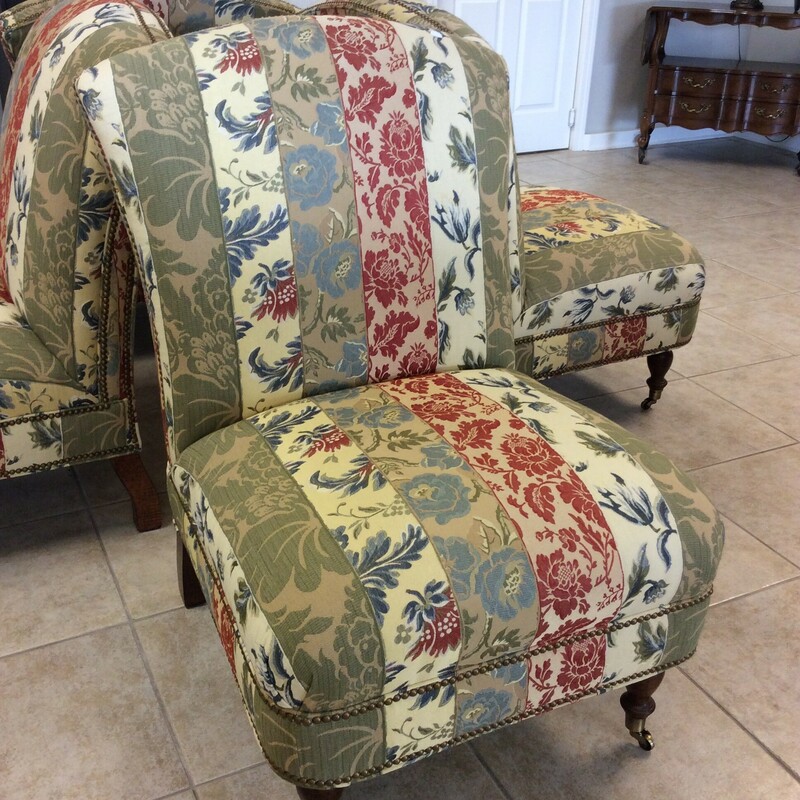 Lovely! This upholstered slipper chair is a little vintagy and will remind you of a simpler time. Upholstered in a colorful floral pattern with a bold nailhead trim. The 2 front legs sit on casters. Best of all, we have 4 of them, priced separtely.