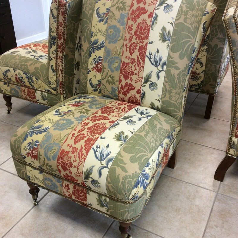 Lovely! This upholstered slipper chair is a little vintagy and will remind you of a simpler time. It's upholstered in a colorful floral pattern. It includes a doulble, bold nailhead trim and the front legs sit on casters. Best of all, we have 4 of them, priced separately.