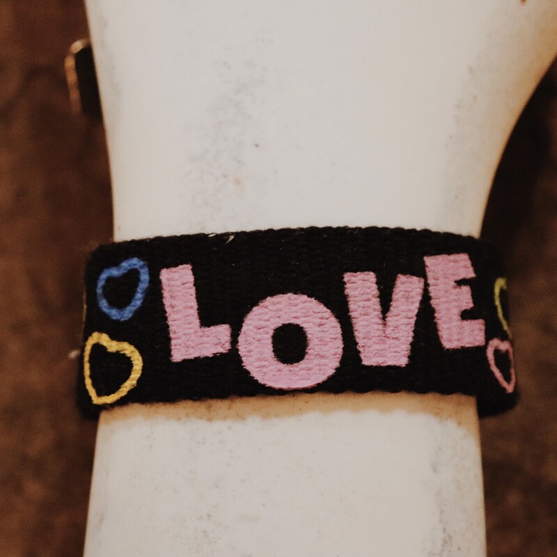 Black Love with hearts cuff bracelet. The cuff is 1 inch wide and 8 inches long. It snaps in the back. Very boho and retro!