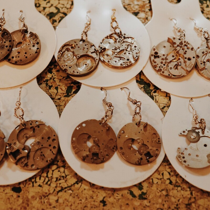These handmade earrings made from old watch parts measure about 1.75 inches long and vary slightly from pair to pair.