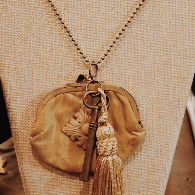 This elegant necklace was hand crafted and has a vintage coin purse as the centerpiece! It is on a 32 inch chain.