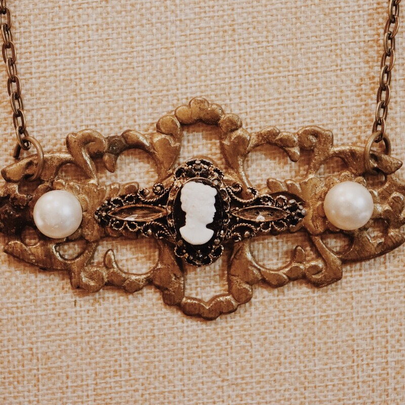 This beautiful, handmade necklace has a vintage dresser handle as the pendant with a cameo in the center! It is on a 22 inch chain.