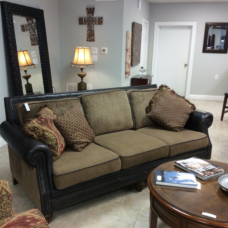 Beautiful Mayo sofa with very pretty leather and fabric combination with leather piping.  The color is a tan and dark brown. The sofa is trimmed in nail heads and sits on bun feet. It also comes with four pillows.