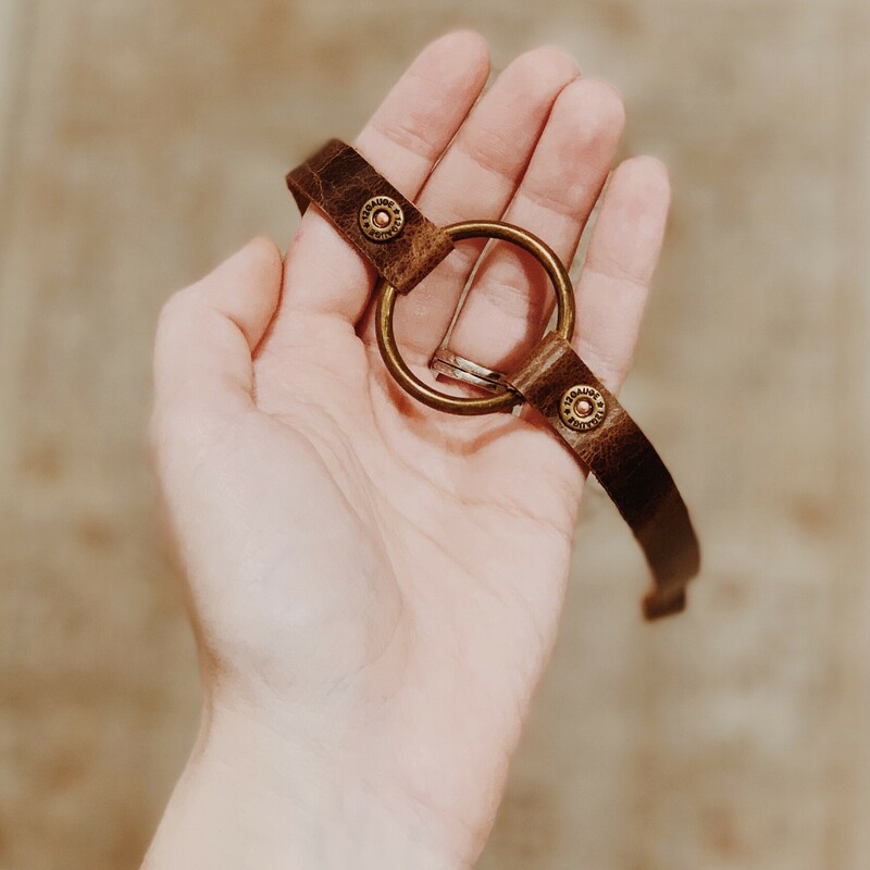 This bracelet by The Olive Branch was carefully designed; hand crafted; and made from genuine leather! It is a continuous strap that measures 20 inches long. The rivets connecting the hoop are miniature shotgun shell rivets!