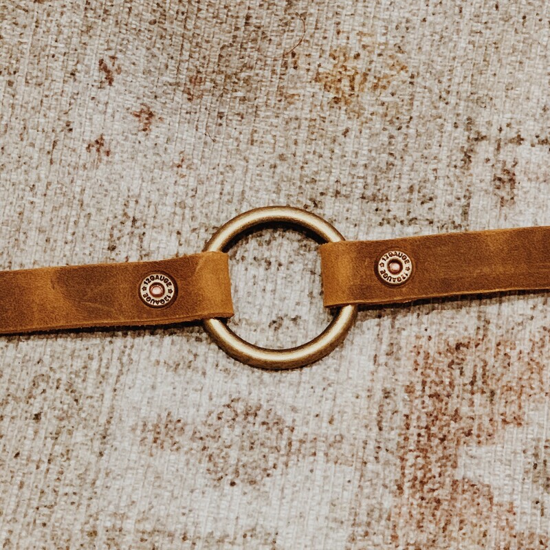 This bracelet by The Olive Branch was carefully designed; hand crafted; and was made from genuine leather! It measures 8 inches in length and has two snaps for two sizes. This hoop bracelet is held together with adorable shotgun shell rivets!