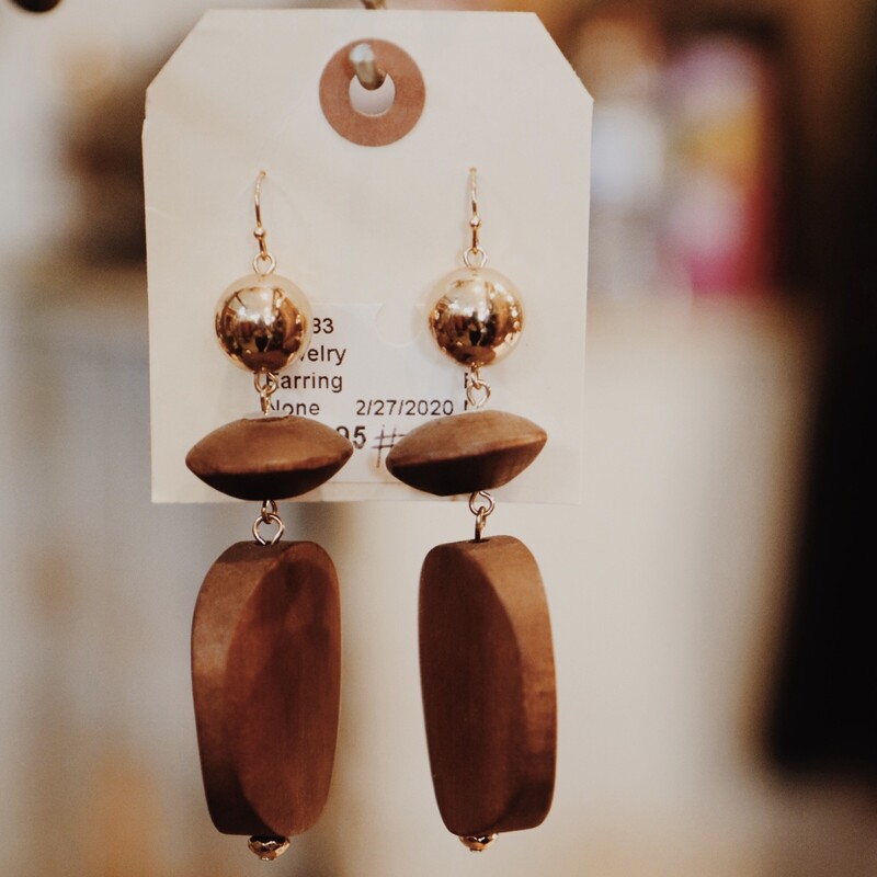 These earrings are made of natural wood in different shapes. They are medium weight. 3 1/2 long.