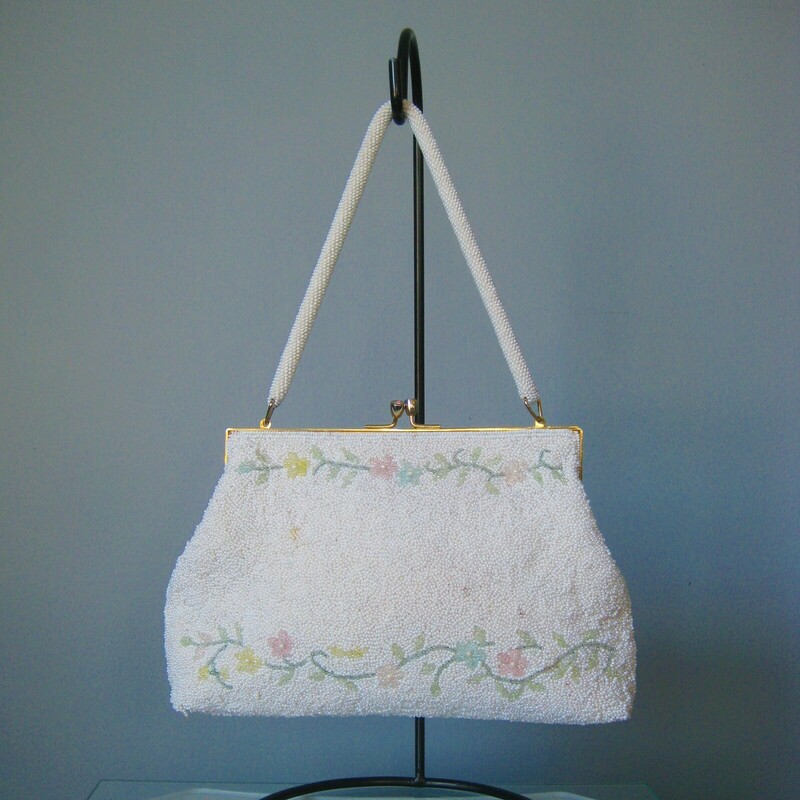 Vtg GMB Beaded, Pink/Wh, Size: None
This is a pretty white beaded frame bag with lines of pink and yellow flowers worked along the top and bottom edge on both front and back.
gold kiss lock frame with jeweled 'kisses' so cute
Pristine white satin lining with one slip pocket
White beaded handle
handmade in Hong Kong by GMB

Excellent like new condition except there is one tiny spot where the white beads have a brown cast as shown.

Width 9.75
Height: 6.5
Depth: 1.75
Handle Drop: 5.75

thanks for looking!
#43959