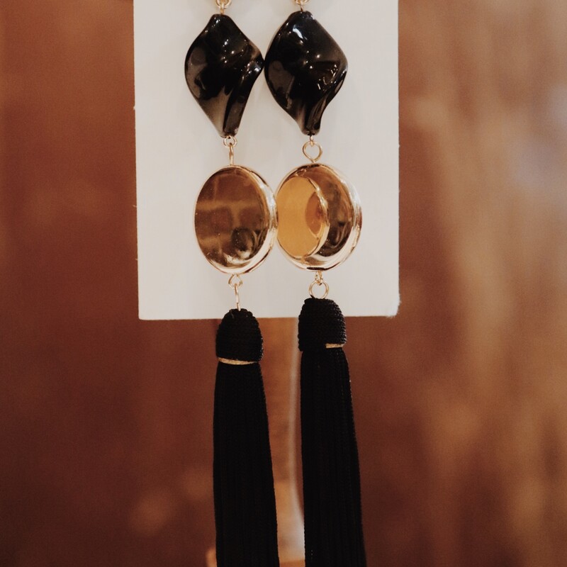 These earrings have a gold button post, connected to a swirly black stone, connected to a larger gold button with a black tassel on the bottom. These are light weight. 6 inches long.