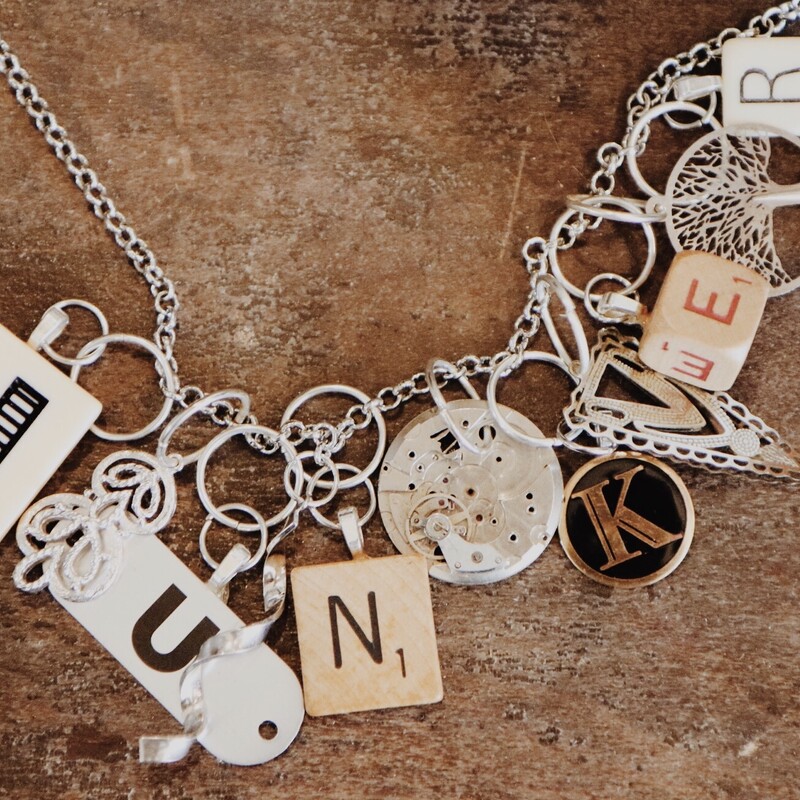 This beautiful necklace spells out junker in game pieces and is on a 26 inch chain!