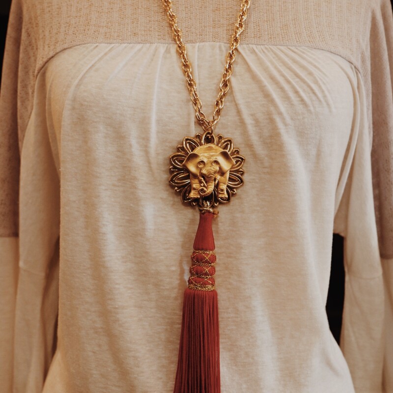 This handmade necklace is on a 30 inch chain and has a 8 inch red tassel!