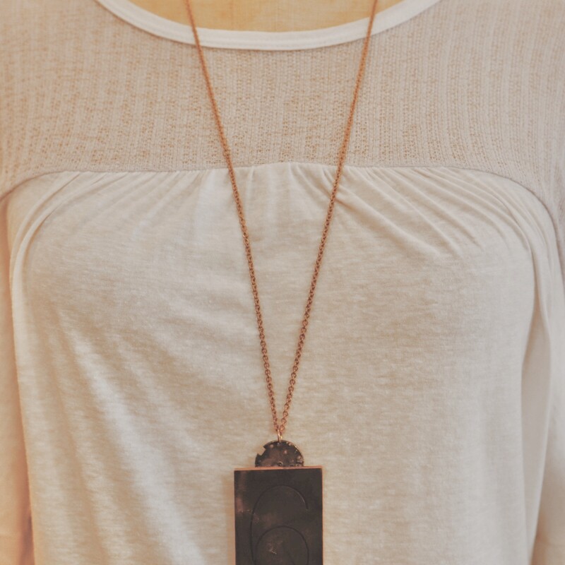 This handmade necklace has a brass plate with 6 engraved and is on a 34 inch chain!