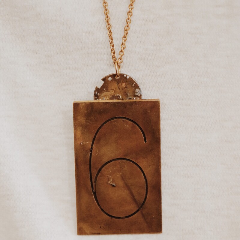 This handmade necklace has a brass plate with 6 engraved and is on a 34 inch chain!