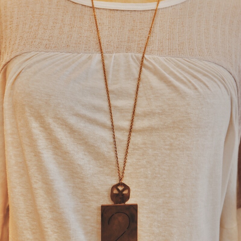 This handmade necklace has a 2 engraved brass plate and hangs on a 34 inch chain!