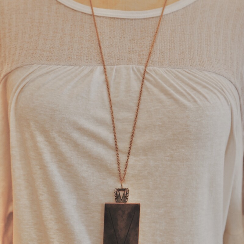 This handmade necklace has a V engraved brass plate and is on a 34 inch chain!