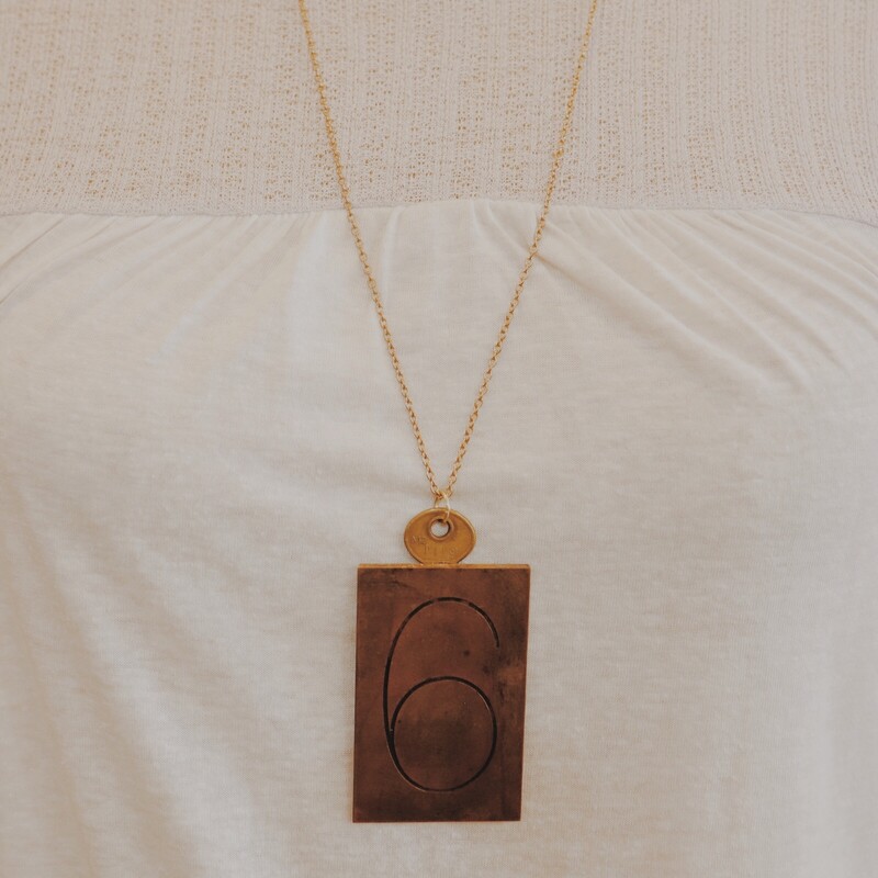 This handmade necklace has a 6 engraved brass plate and is on a 30 inch chain!