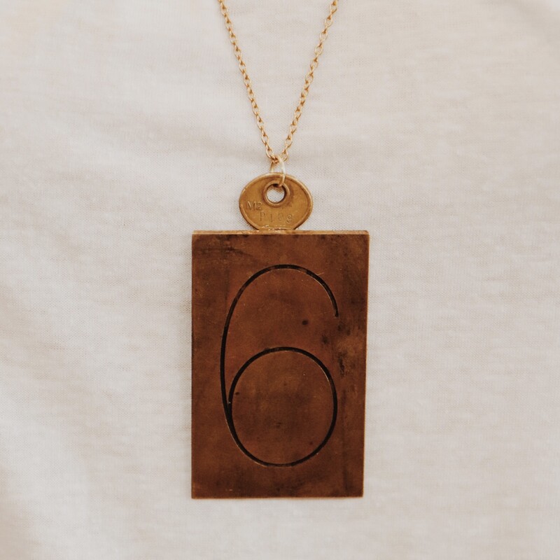 This handmade necklace has a 6 engraved brass plate and is on a 30 inch chain!