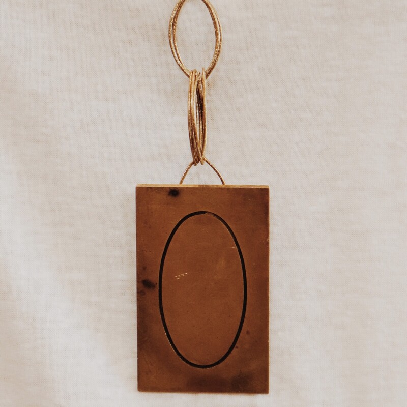 This handmade necklace has 0 engraved brass plate and is on a 30 inch chain!