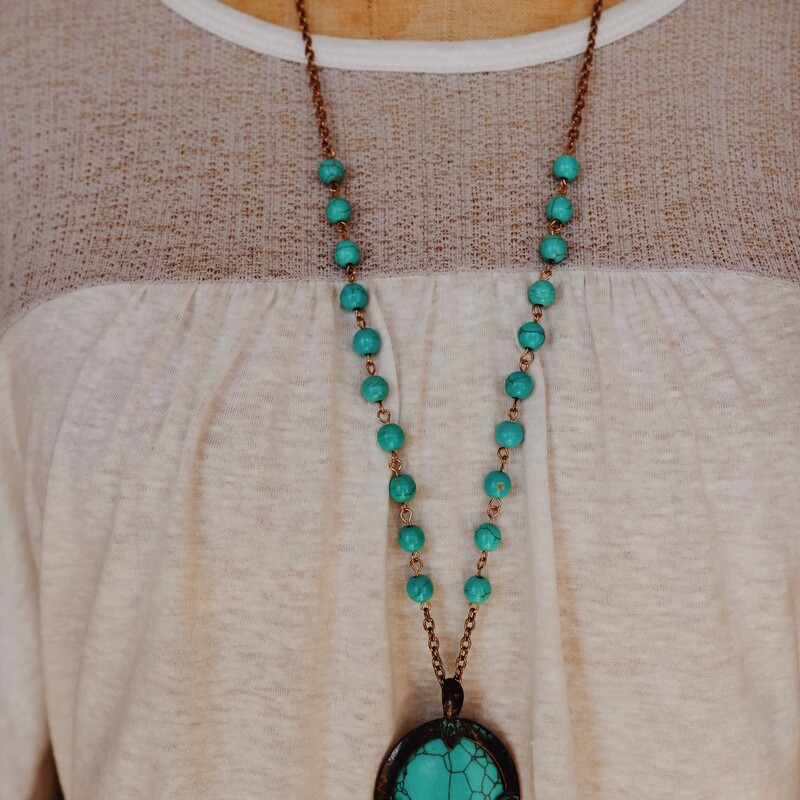 This beautiful necklace is on a 32 inch partially beaded chain and has a gorgeous turquoise stone pendant!