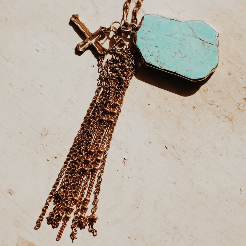 This beautiful necklace has a turquoise stone, a gold cross, and a gold chain tassel! It is on a 30 inch chain!