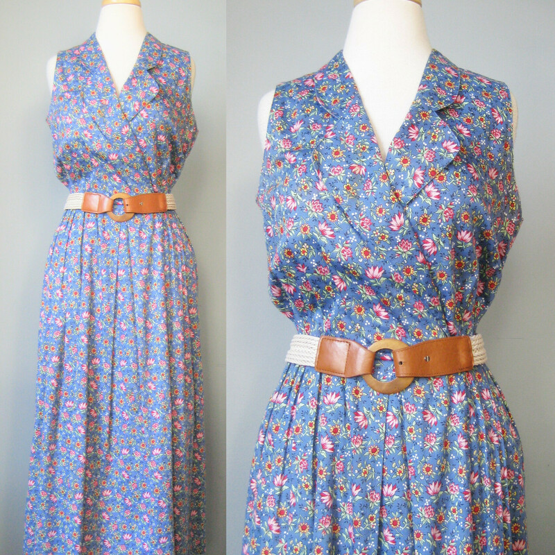 Vtg Bushwacker Floral, Blue, Size: Small
This sleeveless BushwackeUSA day dress is made from a medium weight cotton calico in the prettiest pink floral print on a blue background.  It has a surplice neckline, a very full skirt and pockets.
the waist has been gathered by a cord inside a casing but there isn't any drawstring coming through to the outside so you can't cinch it but you can arranage the gathers along this cord as desired.

unlined

No size tag  fabric tags
Flat measurments:
Armpit to Armpit: 19
Waist: 15
Hips:free
Overall length: 50

Excellent condition with a faint stain near the surplice neckline, brownish , not noticeable unless looking for it.

Thanks for looking!
#39986