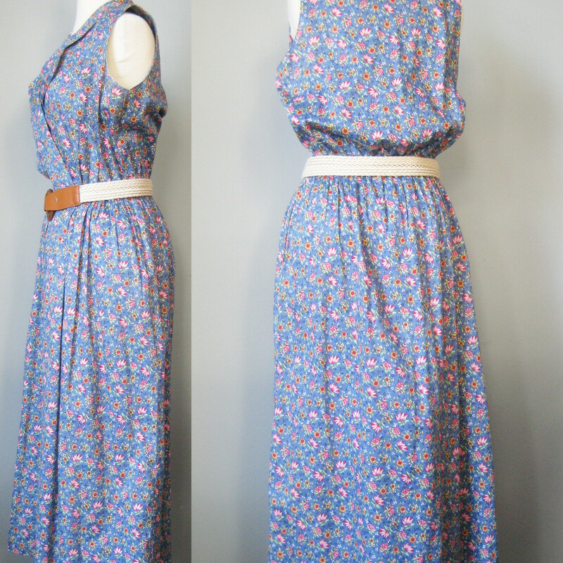 Vtg Bushwacker Floral, Blue, Size: Small
This sleeveless BushwackeUSA day dress is made from a medium weight cotton calico in the prettiest pink floral print on a blue background.  It has a surplice neckline, a very full skirt and pockets.
the waist has been gathered by a cord inside a casing but there isn't any drawstring coming through to the outside so you can't cinch it but you can arranage the gathers along this cord as desired.

unlined

No size tag  fabric tags
Flat measurments:
Armpit to Armpit: 19
Waist: 15
Hips:free
Overall length: 50

Excellent condition with a faint stain near the surplice neckline, brownish , not noticeable unless looking for it.

Thanks for looking!
#39986