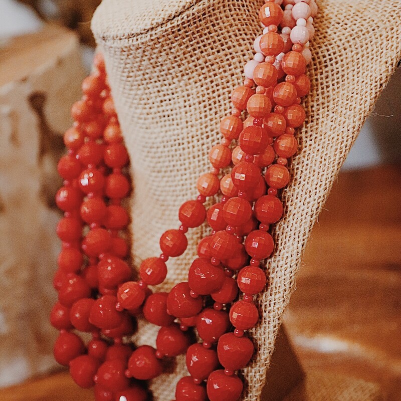 Red Shades Beaded Necklace, 5 layered beaded chains that fade from pink. peach, to red. The longest layer is 10 inches the shortest layer in 7.5 inches