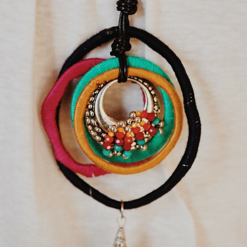 The perfect way to top off an outfit! The deep tones in this necklace are beautiful! measuring 24 inches long with beaded tassle pendant.