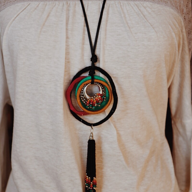 The perfect way to top off an outfit! The deep tones in this necklace are beautiful! measuring 24 inches long with beaded tassle pendant.