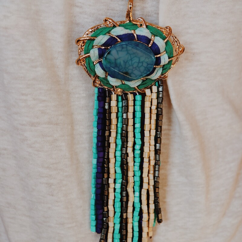 This necklace is such a unique piece! If you love bold and unique jewelry, this is the necklace for you! Avalible in blue tones or nuetral brown tones! Measuring 24 inches long including the stone tassle pendant.