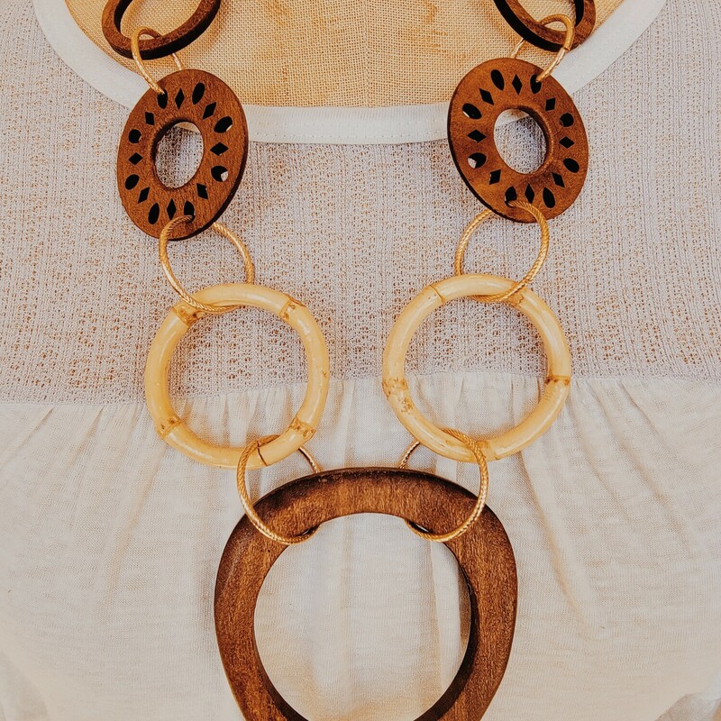 This wooden necklace is on a 28 inch chain with a 3 inch extender!