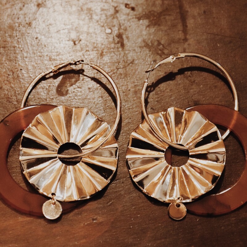 Dangle Jangle Earrings These earrings are composed of gold metal circles and brown resin. Measuring 3.75 inches long.
